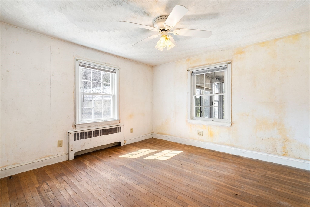 14 Hillside Road Braintree, MA 02184 - Photo 21 of 42 an empty room with wooden floor chandelier fan and windows