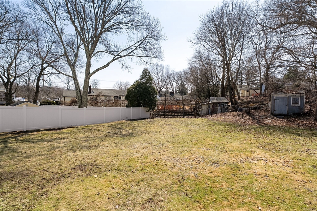 14 Hillside Road Braintree, MA 02184 - Photo 36 of 42 a backyard of a house with a large tree