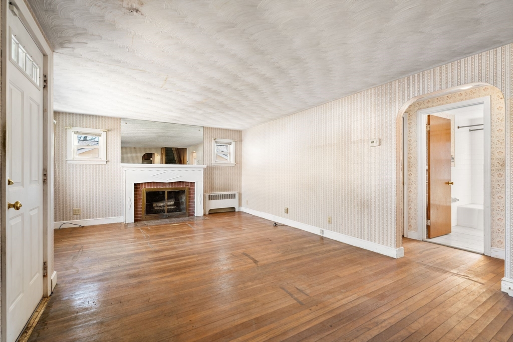 14 Hillside Road Braintree, MA 02184 - Photo 6 of 42 a view of a livingroom with an empty space and a fireplace