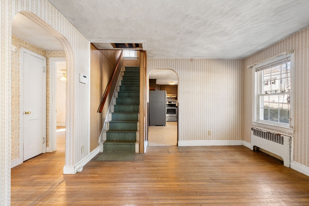 14 Hillside Road Braintree, MA 02184 - Photo 9 of 42 a view of an empty room with wooden floor and stairs