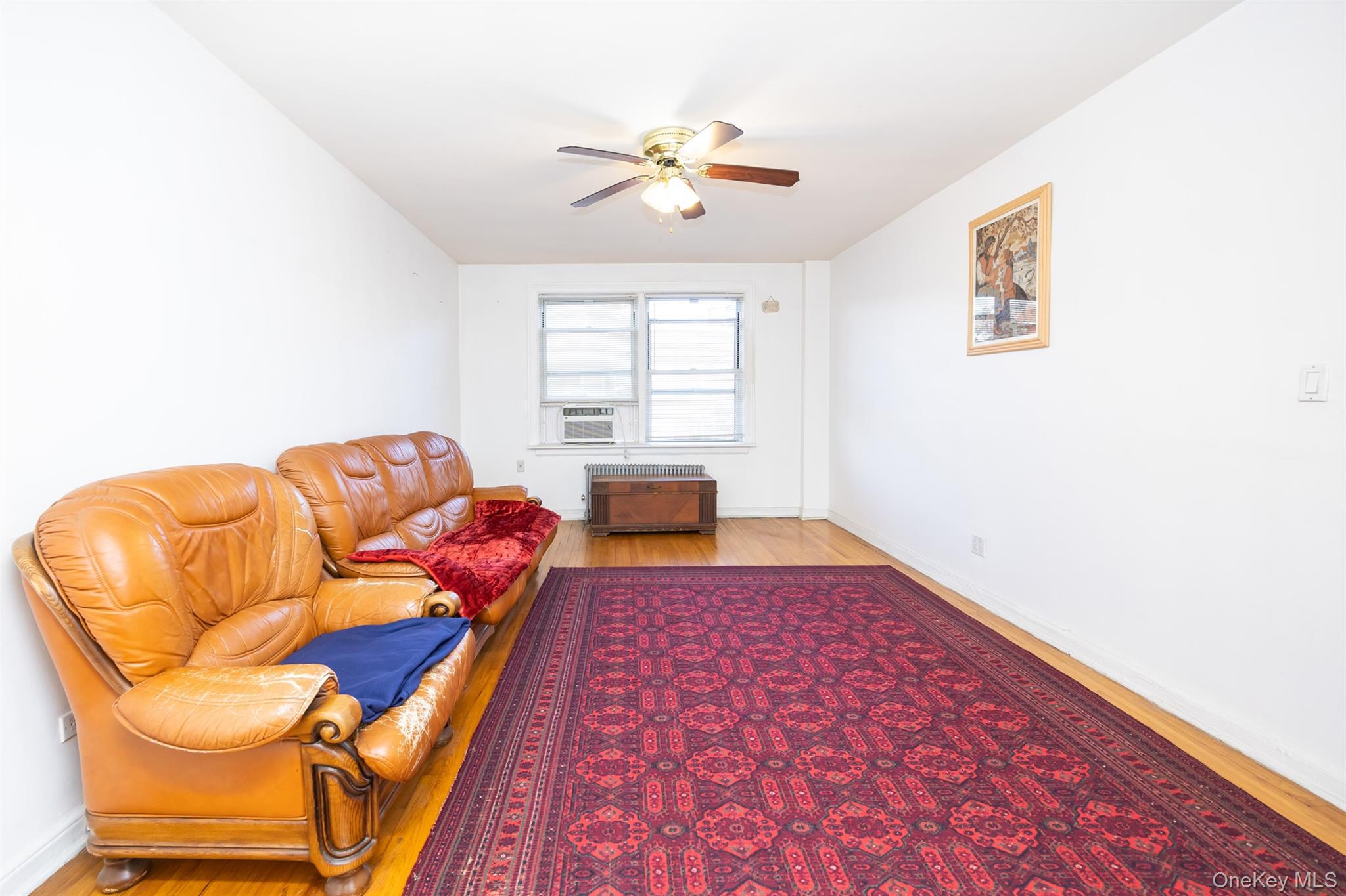 141-24 78th Road, Unit 3A Queens, NY 11367 - Photo 4 of 15 a bedroom with a bed and window