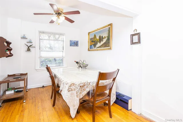 a view of a dining room with furniture and a chandelier
