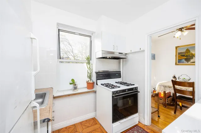 a kitchen with stainless steel appliances a stove a sink and a microwave