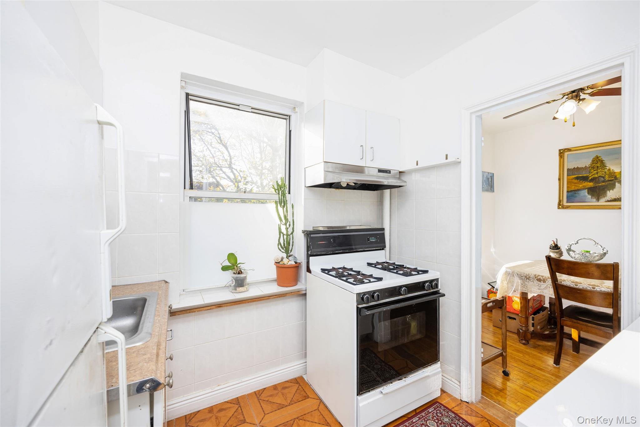 141-24 78th Road, Unit 3A Queens, NY 11367 - Photo 7 of 15 a kitchen with stainless steel appliances a stove a sink and a microwave