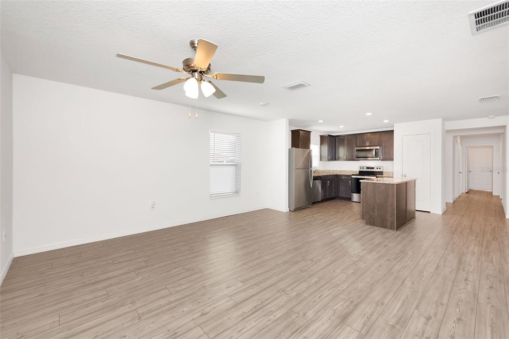 8646 Pinetop Ridge Lane Brooksville, FL 34613 - Photo 14 of 76 a kitchen with stainless steel appliances a refrigerator and a stove top oven