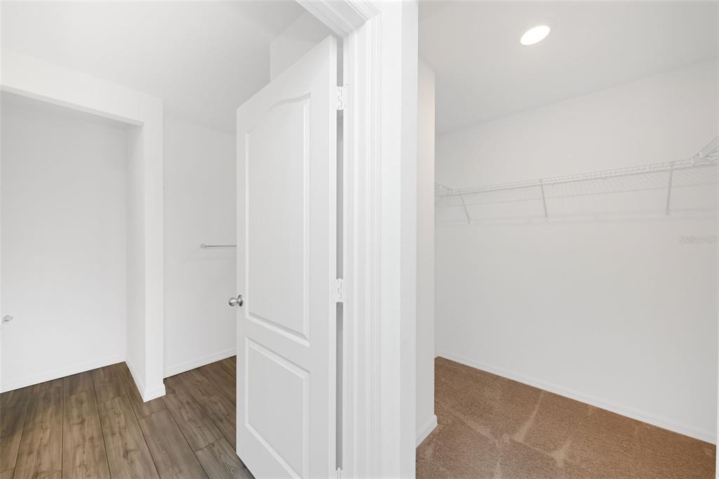 8646 Pinetop Ridge Lane Brooksville, FL 34613 - Photo 19 of 76 a view of a hallway with wooden floor