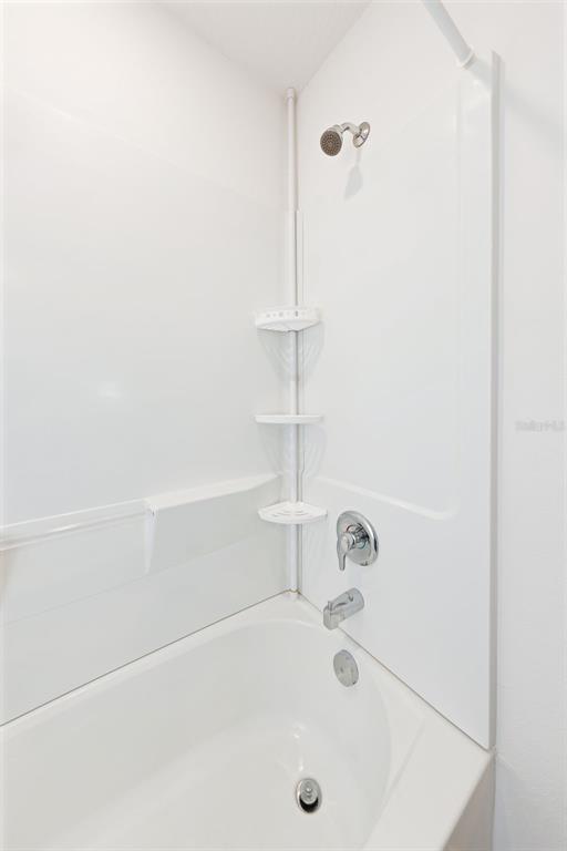 8646 Pinetop Ridge Lane Brooksville, FL 34613 - Photo 27 of 76 a bathroom with a tub