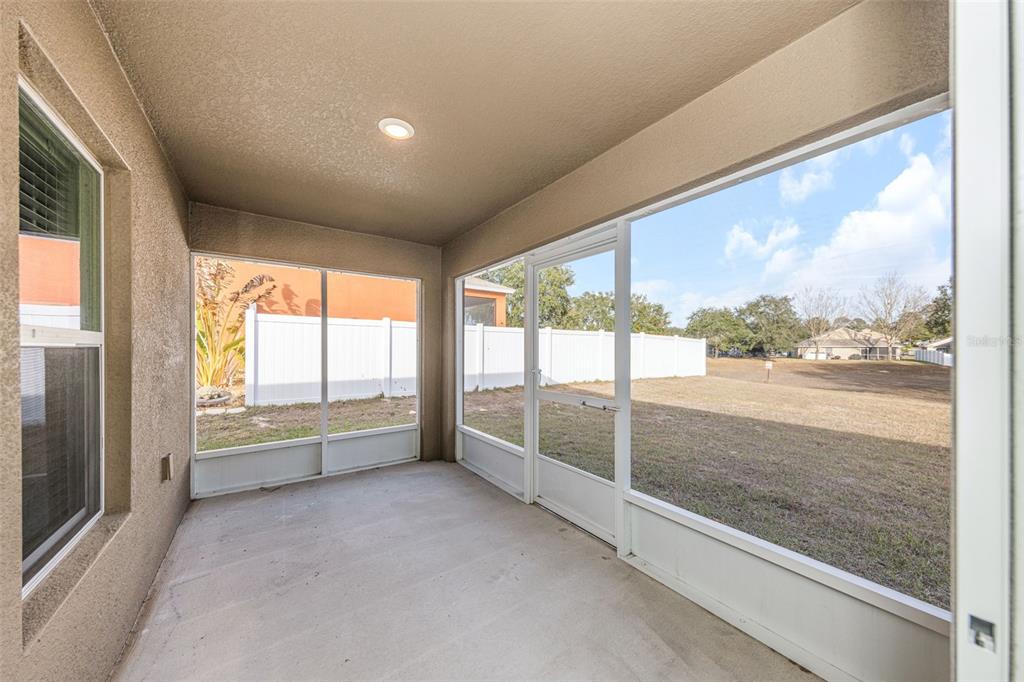 8646 Pinetop Ridge Lane Brooksville, FL 34613 - Photo 36 of 76 a view of an empty room with a large window and kitchen view