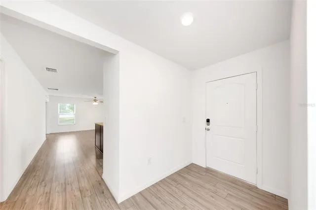 a kitchen with granite countertop a refrigerator stove and sink