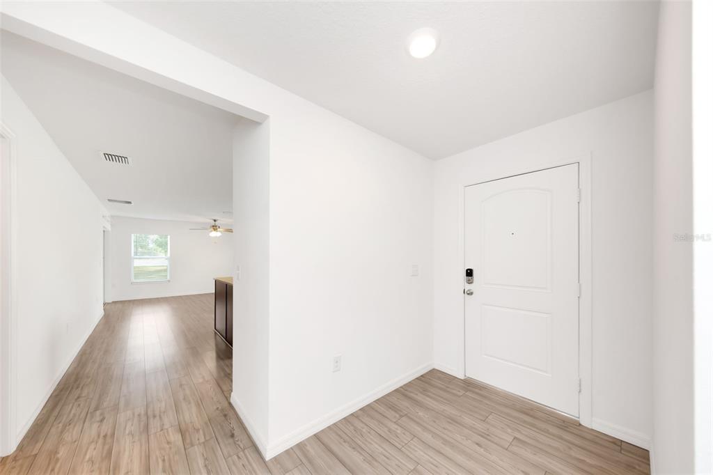 8646 Pinetop Ridge Lane Brooksville, FL 34613 - Photo 6 of 76 a view of a hallway with wooden floor