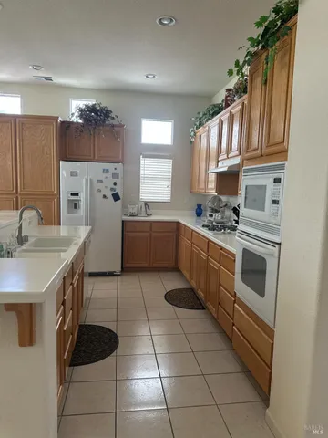 a kitchen with stainless steel appliances a stove sink and cabinets
