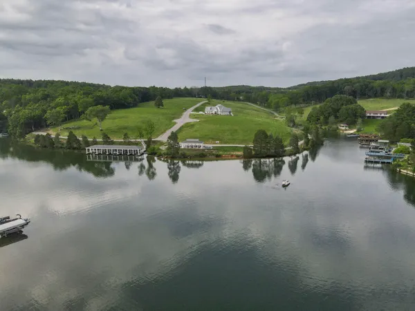 an aerial view of a house with a swimming pool outdoor seating and yard