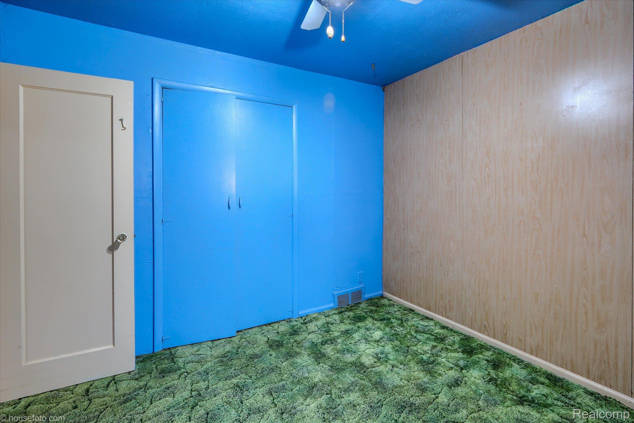 1325 Barnes Lake Road North Branch, MI 48461 - Photo 17 of 42 Unfurnished bedroom with wooden walls, carpet floors, a ceiling fan, and a closet