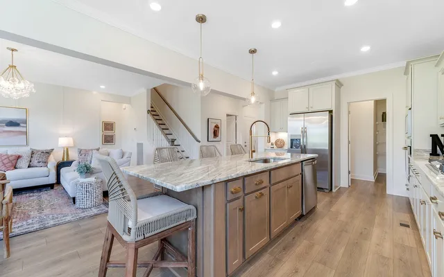 a kitchen with center island a sink appliances and a counter top space