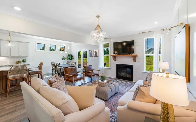 a living room with furniture a flat screen tv and a fireplace