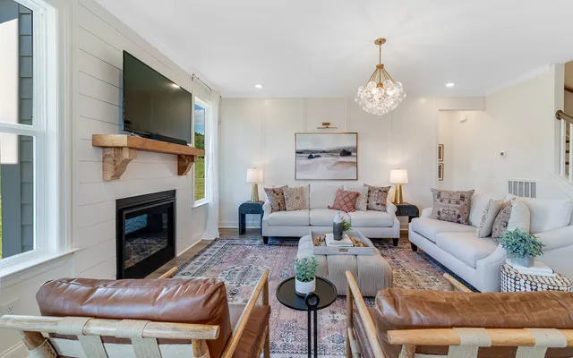 a living room with furniture a fireplace and a flat screen tv