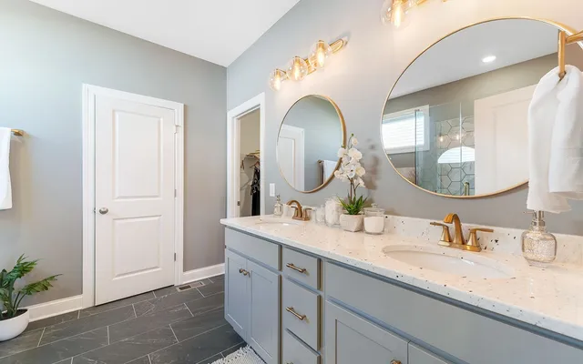 a bathroom with a double vanity sink and a mirror