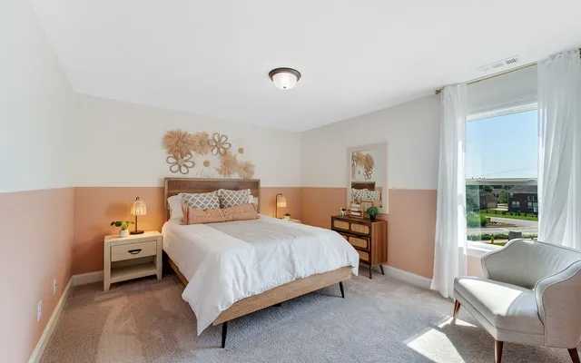 a bedroom with a bed and window