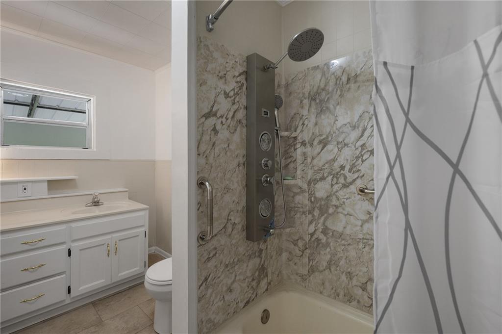 154 County Line Road Southwest Plainville, GA 30733 - Photo 22 of 27 a bathroom with a shower a sink and a toilet