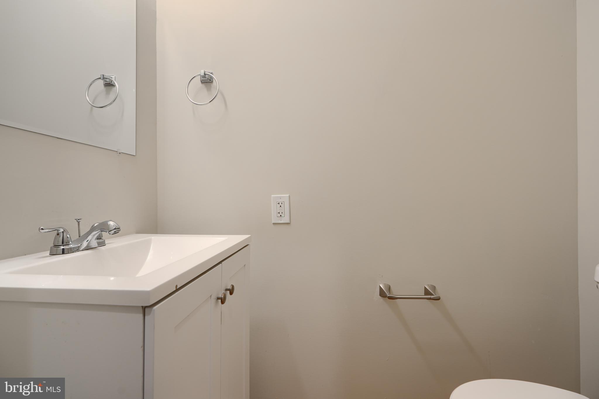 3308 Walbrook Avenue Baltimore, MD 21216 - Photo 14 of 32 a bathroom with a sink and mirror