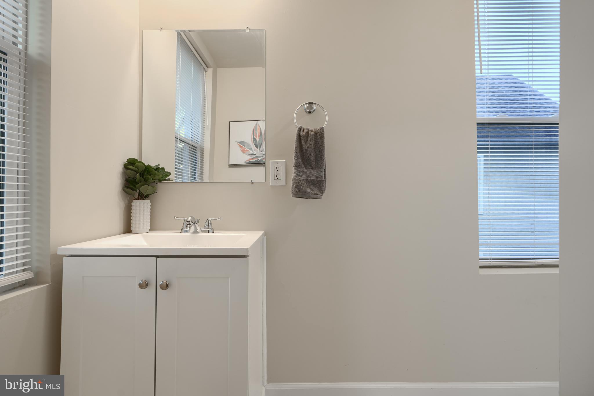 3308 Walbrook Avenue Baltimore, MD 21216 - Photo 23 of 32 a bathroom with a sink and a mirror
