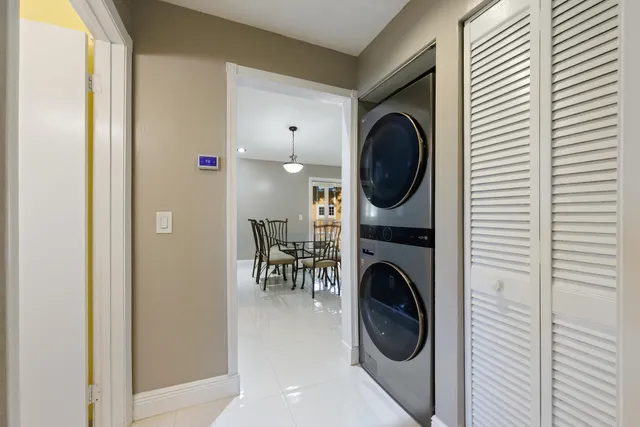 a bathroom with a granite countertop sink a toilet and a large mirror