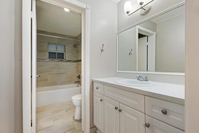 a white toilet sitting next to a bath tub