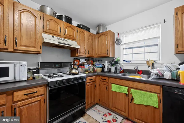 a kitchen with stainless steel appliances a stove a sink dishwasher and cabinets