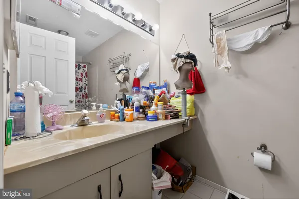 a bathroom with a sink mirror and vanity