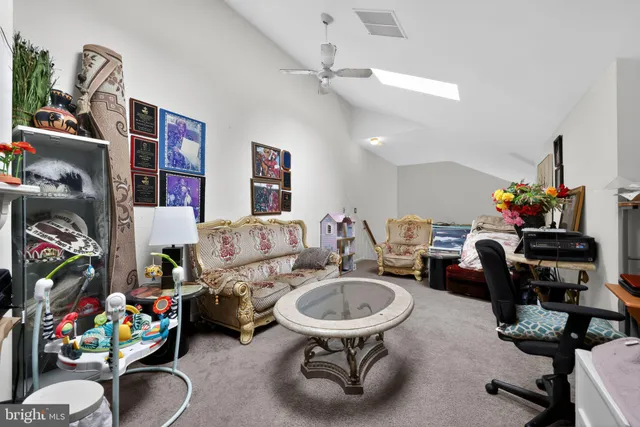 a living room with furniture and a gym equipment