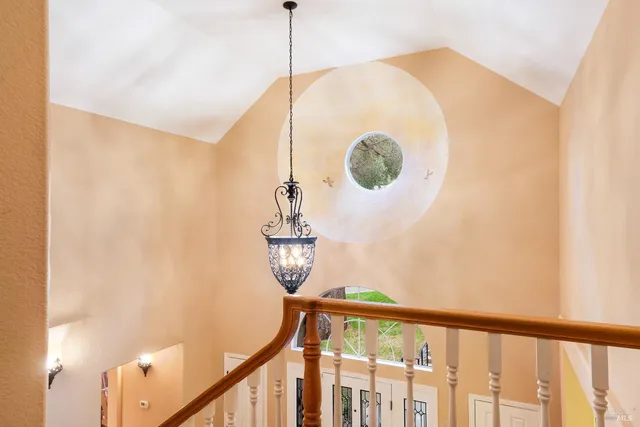 a bedroom with a bed and painting on the wall