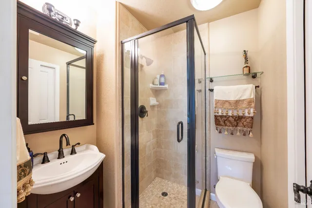 a bathroom with a double vanity sink mirror and shower