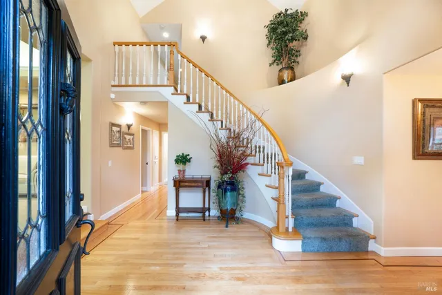 a view of entryway with wooden floor and stairs