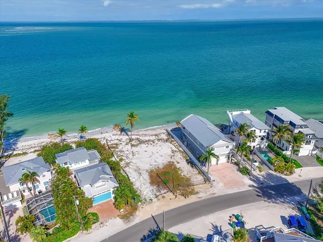 an aerial view of a house with a ocean view
