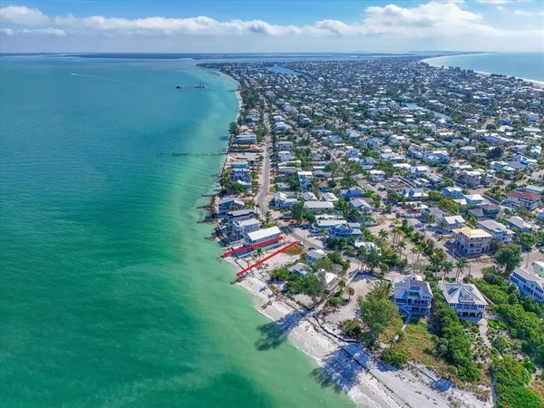 an aerial view of a houses with a yard
