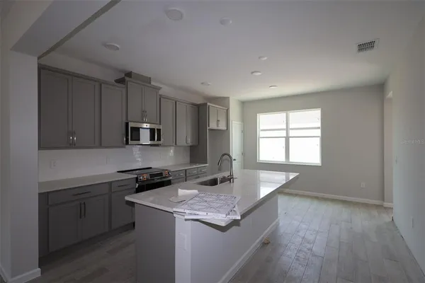 a kitchen that has a sink and a stove in it