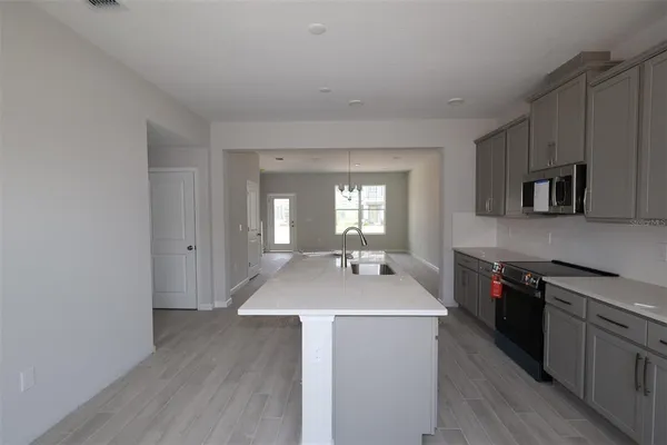 a kitchen with sink a stove and refrigerator