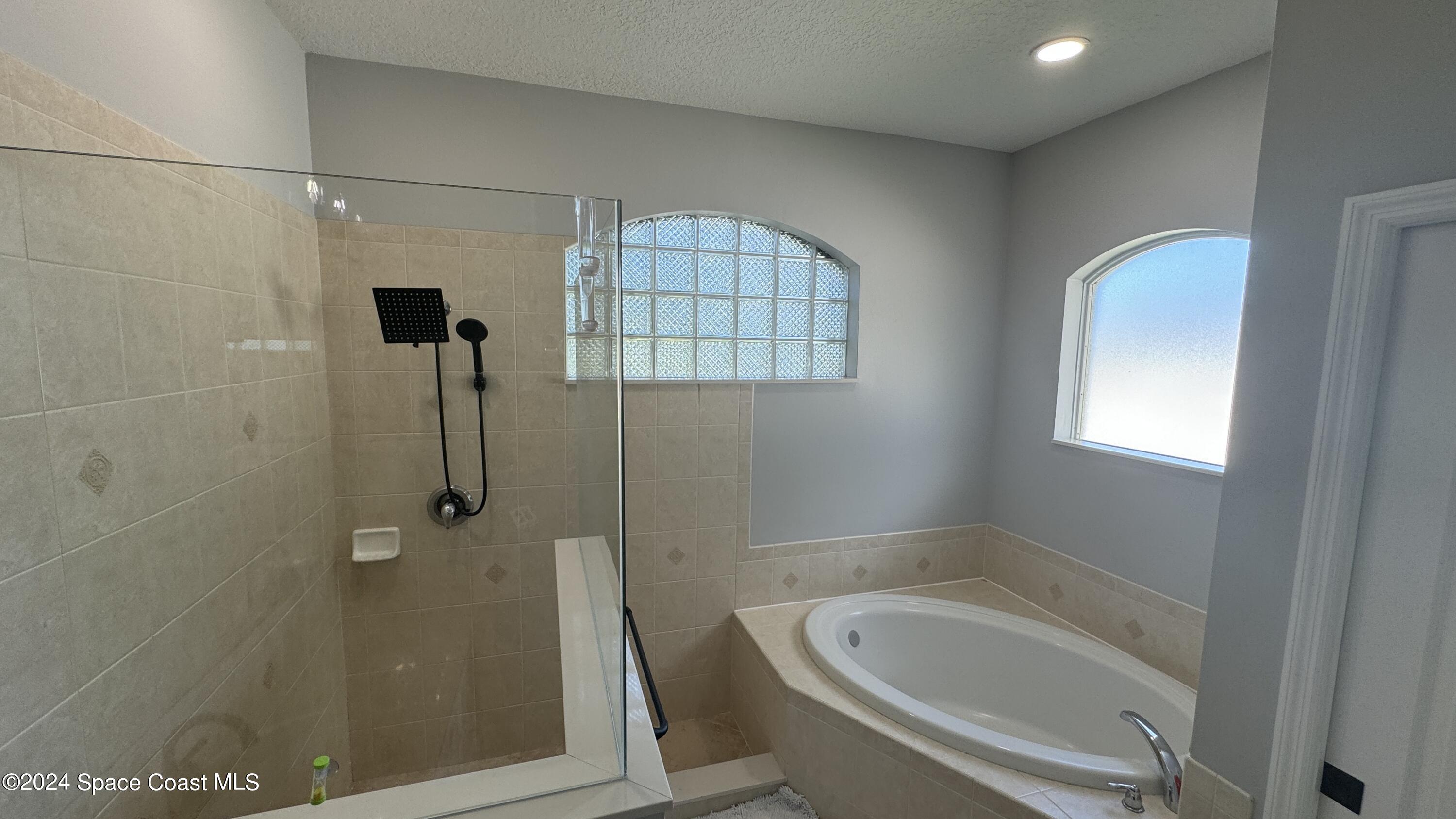 1471 Tamango Drive Melbourne, FL 32904 - Photo 16 of 23 a bathroom with a tub and shower