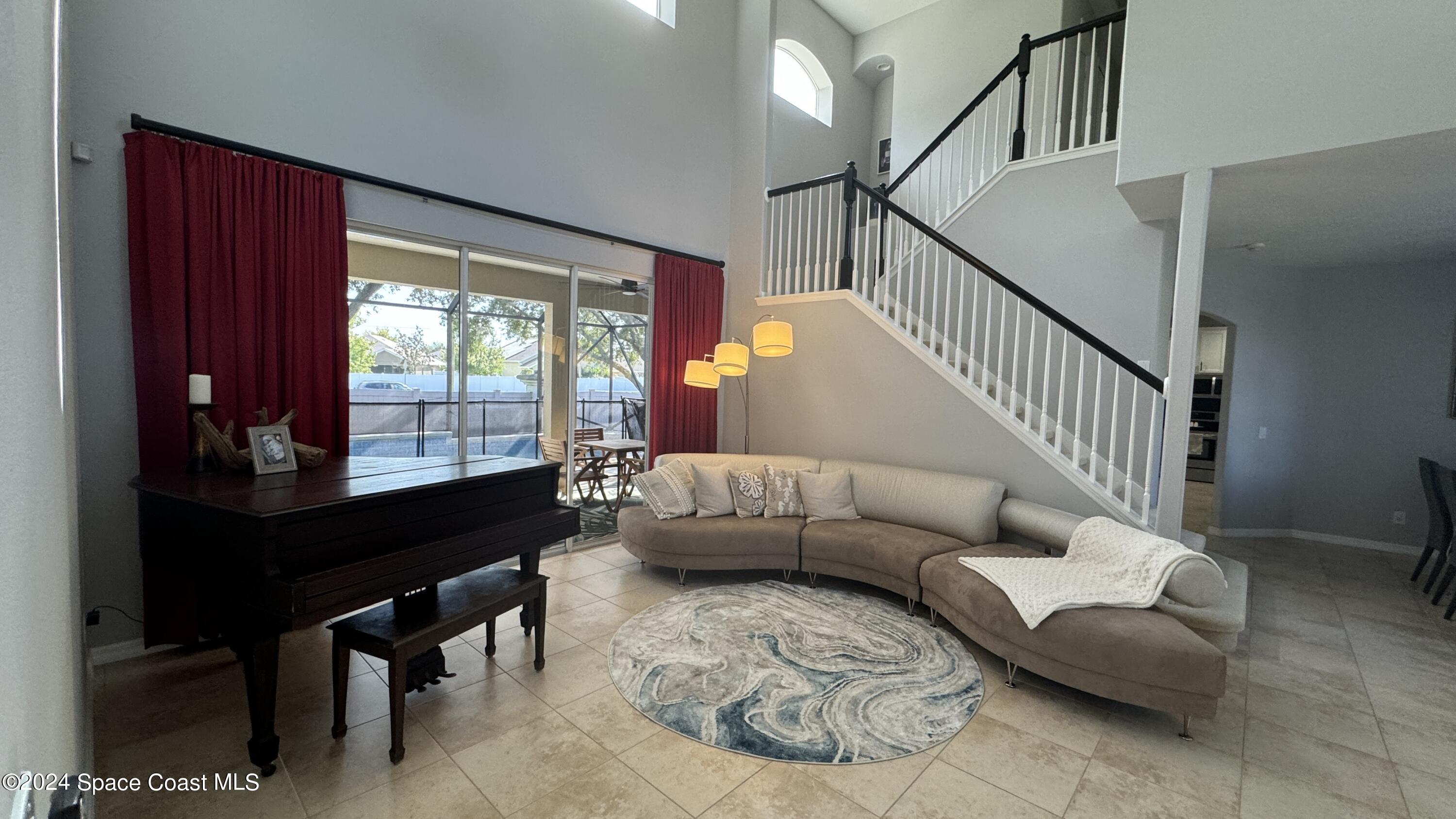 1471 Tamango Drive Melbourne, FL 32904 - Photo 4 of 23 a living room with furniture and a large window