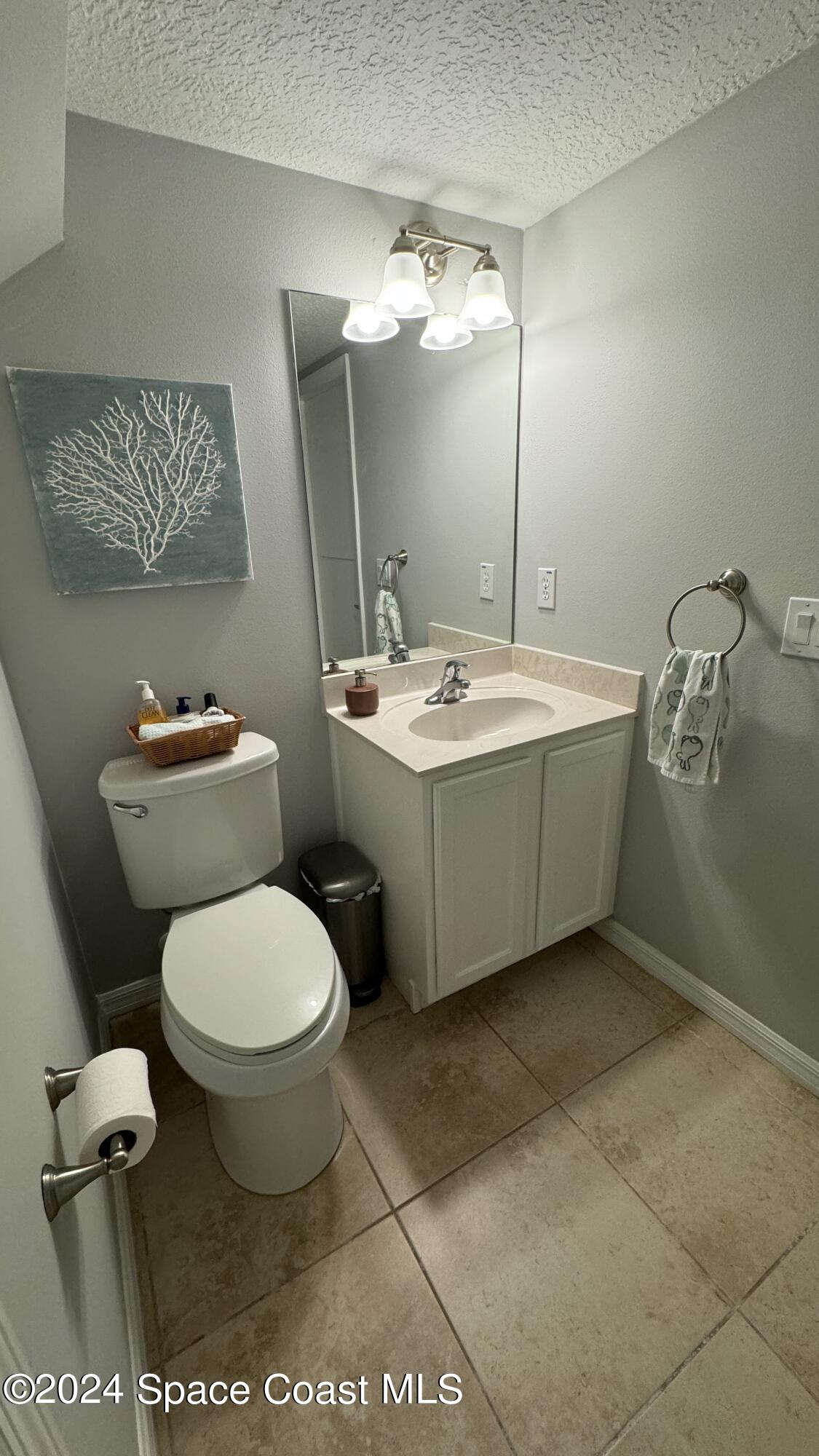 1471 Tamango Drive Melbourne, FL 32904 - Photo 7 of 23 a bathroom with a toilet sink and mirror