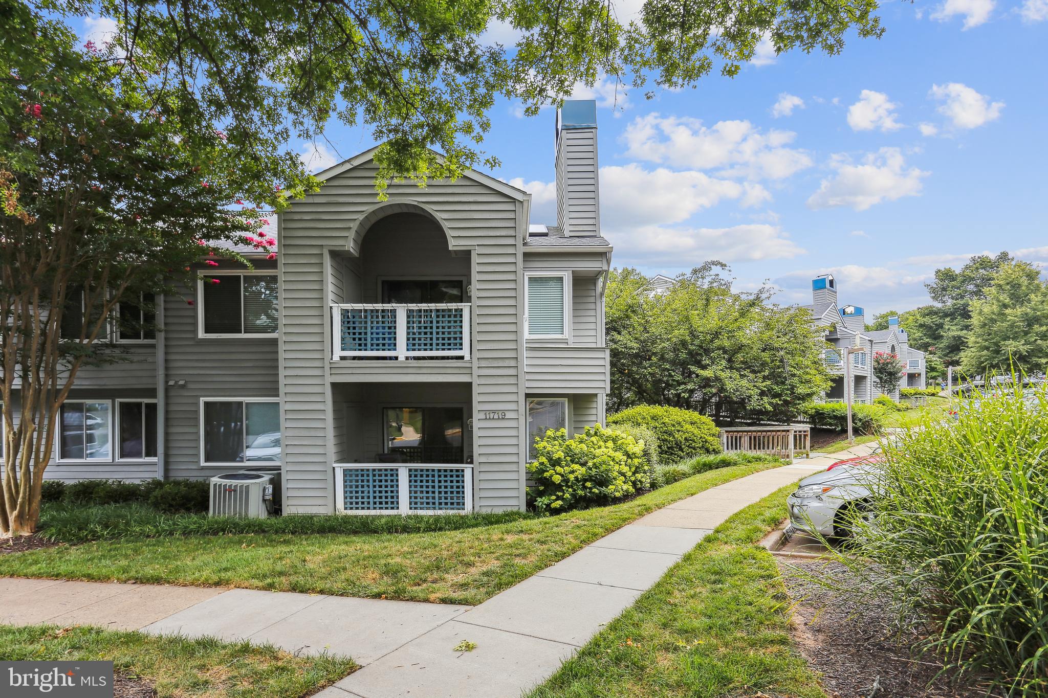 11719 E Summerchase Circle, Unit 1719E Reston, VA 20194 - Photo 17 of 26 a front view of a house with a yard