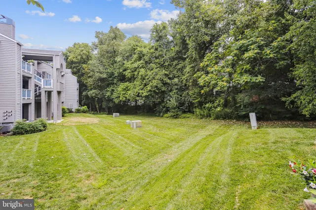 a swimming pool with trees in the background