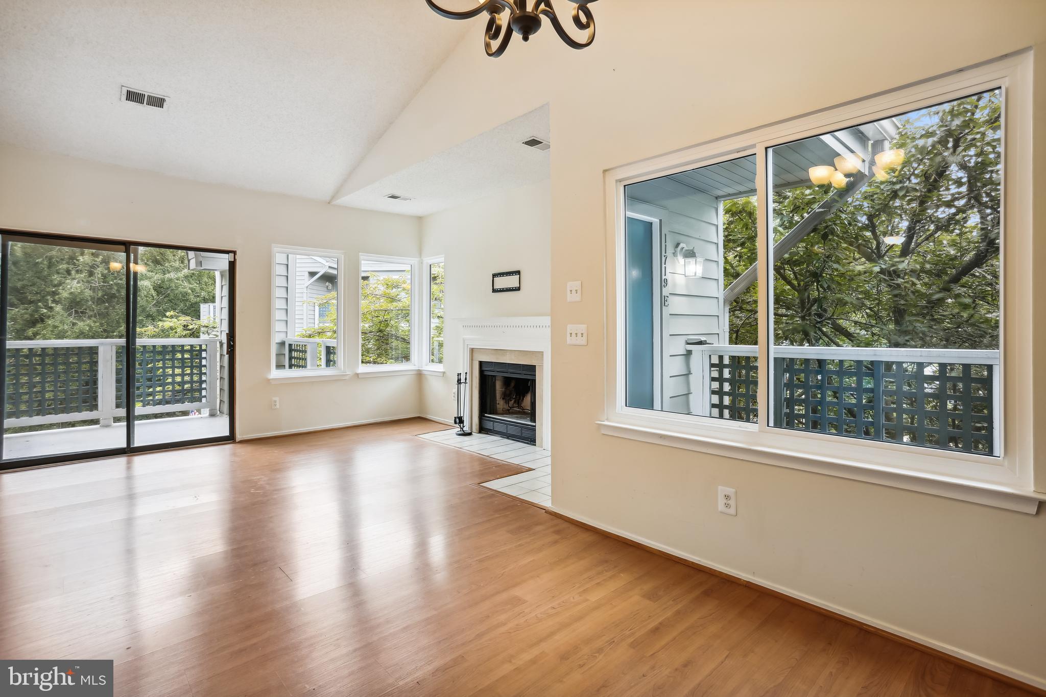 11719 E Summerchase Circle, Unit 1719E Reston, VA 20194 - Photo 2 of 26 a view of an empty room with wooden floor and a window