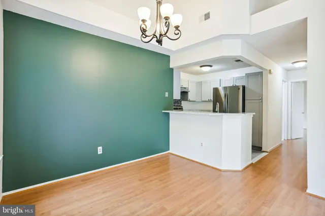 a view of a kitchen with wooden floor and a sink
