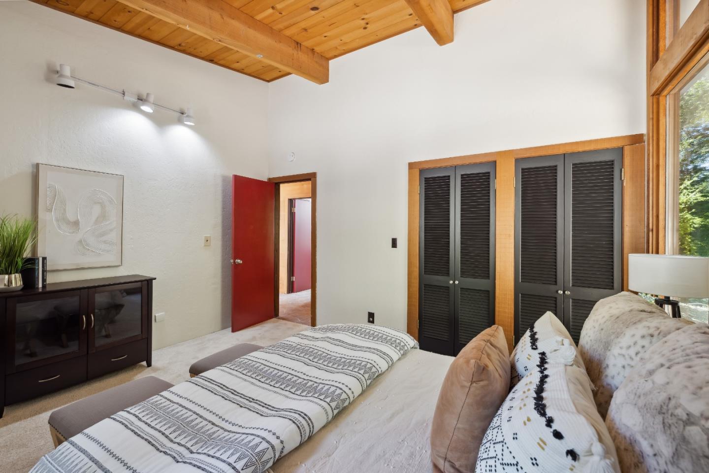 10845 Vineland Road Ben Lomond, CA 95005 - Photo 31 of 77 a bedroom with a large bed and a chandelier