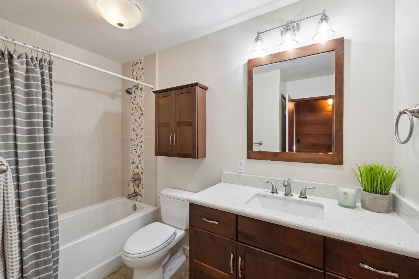 10845 Vineland Road Ben Lomond, CA 95005 - Photo 32 of 77 a bathroom with a granite countertop sink toilet a large mirror a bathtub and shower