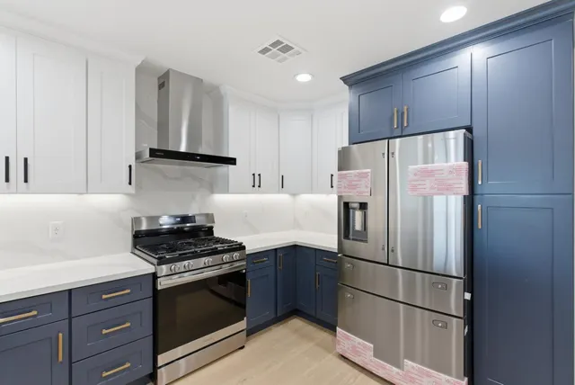 a kitchen with granite countertop a stove and a sink