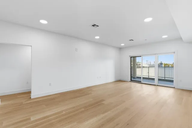 a view of a kitchen with a sink and cabinets