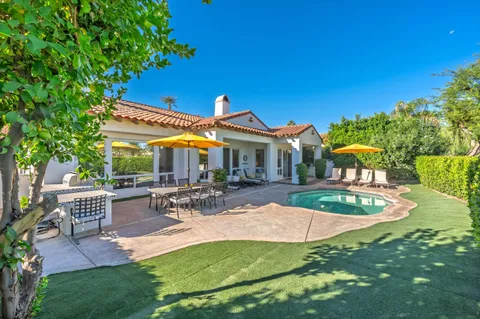 a view of house with swimming pool outdoor seating and yard