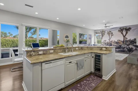 a kitchen with stainless steel appliances granite countertop a stove and a sink